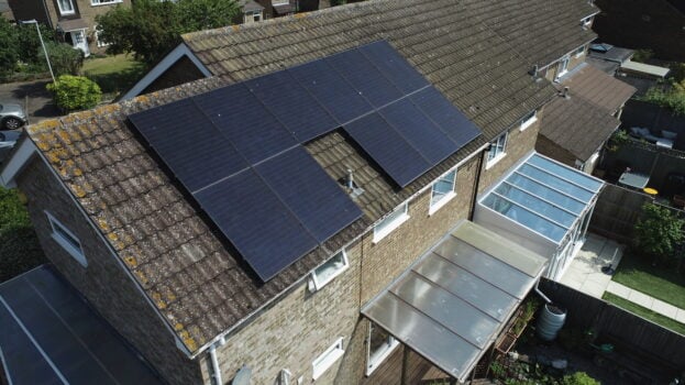 Solar PV panels installed on a roof around a vent.