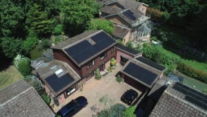 A group of buildings with Solar PV panels on the roof taken from above.