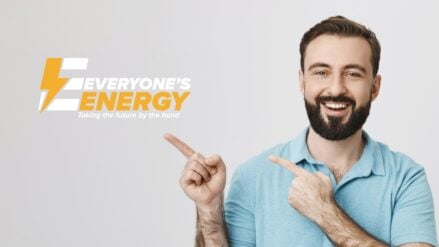 A man smiling and pointing at the Everyone's Energy logo.